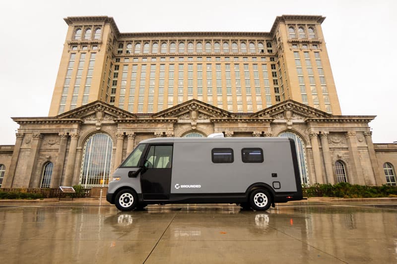Grounded G2 specialty electric RV staged in front of Michigan Central Station, Detroit.